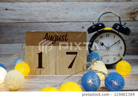 Wooden Calendar Showing the Date of August 17th. Day 17 of August month 129861384