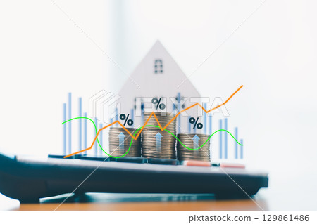 Stack of coins with glowing house icon and upward arrows, symbolizing real estate investment growth. Business growth to invest money in stock market, financial banking to income of investment. 129861486