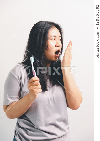 Asian girl expresses dislike, person express negative feeling, concept business complaint from customer ensuring employee satisfaction negative feedback to prevent mental strain customer dislike 129861582
