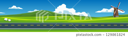 Banner background of horizontal or landscape view of asphalt road. windmill house stands tall on a hillside in a wide. Background of mountain with white clouds and bright sky. 129861824
