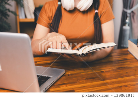Homeschool Asian girl student learning virtual internet online class from school teacher by remote meeting. Female teaching math by headphone. education concept. student with computer study at school Homeschool Asian girl student learning virtual internet online class from school teacher by remote meeting. Female teaching math by headphone. education concept. student with computer study at school 129861915