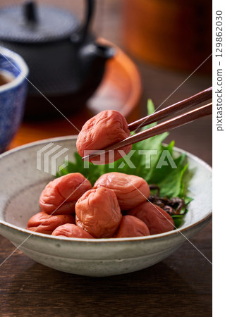 Small bowl of pickled plums | A staple of Japanese cuisine: pickles and preserved foods Small bowl of pickled plums | A staple of Japanese cuisine: pickles and preserved foods 129862030