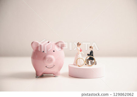 Save money for wedding and planning wedding concept. Sustainable financial goal for family life or married life. Miniature wedding on rows of rising coins, depicts savings or growth for new family. Save money for wedding and planning wedding concept. Sustainable financial goal for family life or married life. Miniature wedding on rows of rising coins, depicts savings or growth for new family. 129862062