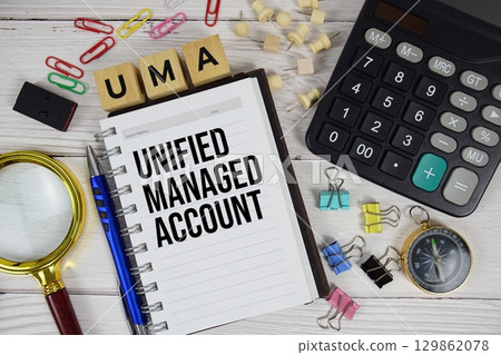 UMA Unified Managed Account acronym on notepad, business and financial concept background UMA Unified Managed Account acronym on notepad, business and financial concept background 129862078