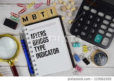 MBTI Myers Briggs Type Indicator acronym on notepad, business and financial concept background MBTI Myers Briggs Type Indicator acronym on notepad, business and financial concept background 129862089