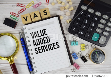 VAS Value Added Services acronym on notepad, business and financial concept background 129862090