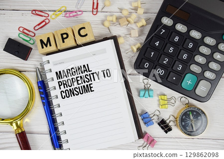 MPC Marginal Propensity to Consume acronym on notepad, Business concept background 129862098