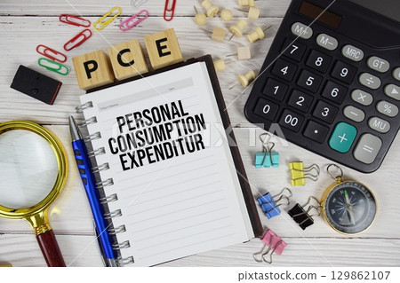 PCE Personal Consumption Expenditure acronym on notepad, business and financial concept background PCE Personal Consumption Expenditure acronym on notepad, business and financial concept background 129862107