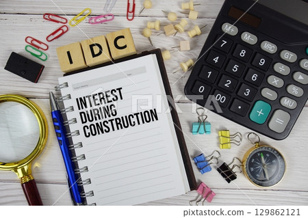 IDC Interest During Construction acronym on notepad, business and financial concept background IDC Interest During Construction acronym on notepad, business and financial concept background 129862121
