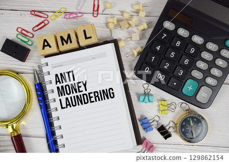 AML - Anti Money Laundering acronym on notepad, Business and Financial concept background 129862154