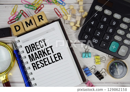 DMR - Direct Market Reseller acronym on notepad, Business and Financial concept background 129862158