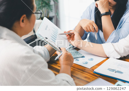 Teamwork with business people analysis cost graph on desk at meeting room. partnership analysis graph company financial budget report, cost work progress planning, business team analysis graph data 129862247