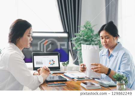 People meeting using laptop computer, calculator, stock market chart paper for analysis plans to improve quality. Team working on project. Analysis business brainstorming corporate smart Concept. People meeting using laptop computer, calculator, stock market chart paper for analysis plans to improve quality. Team working on project. Analysis business brainstorming corporate smart Concept. 129862249