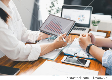 Teamwork meeting, business people in office workplace. Collaboration, technology and worker, employees with touchscreen planning sales, research or financial strategy, staff for conversation, graph 129862250