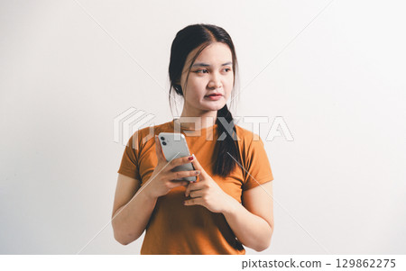 Asian girl expresses dislike, person express negative feeling, concept business complaint from customer ensuring employee satisfaction negative feedback to prevent mental strain customer dislike 129862275