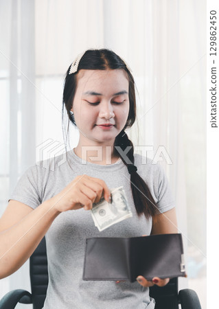 Business, finance and employment, entrepreneur and money concept. Successful young asian office manager, businesswoman showing earned cash, smiling satisfied holding dollars, money dollar bills 129862450