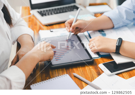 Teamwork meeting, business people in office workplace. Collaboration, technology and worker, employees with touchscreen planning sales, research or financial strategy, staff for conversation, graph 129862505