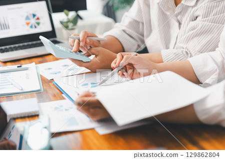 Financial business team in office, financial expert analyze business report graph and finance chart at corporate office. Concept of finance economy, banking business and stock market research. 129862804