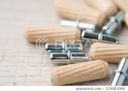 Close-up of wooden dowels and iron shelf bracket dowels Close-up of wooden dowels and iron shelf bracket dowels 129863066