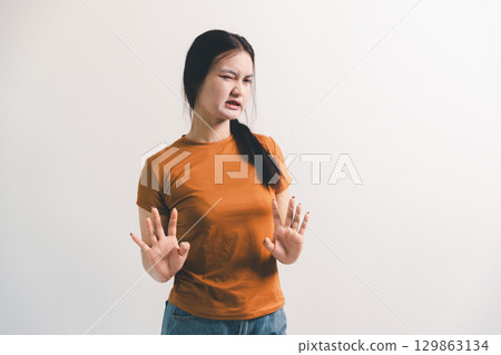 Asian girl expresses dislike, person express negative feeling, concept business complaint from customer ensuring employee satisfaction negative feedback to prevent mental strain customer dislike Asian girl expresses dislike, person express negative feeling, concept business complaint from customer ensuring employee satisfaction negative feedback to prevent mental strain customer dislike 129863134
