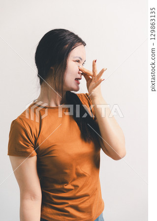 Asian girl expresses dislike, person express negative feeling, concept business complaint from customer ensuring employee satisfaction negative feedback to prevent mental strain customer dislike 129863135