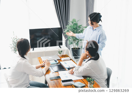 People meeting using laptop computer, calculator, stock market chart paper for analysis plans to improve quality. Team working on project. Analysis business brainstorming corporate smart Concept. People meeting using laptop computer, calculator, stock market chart paper for analysis plans to improve quality. Team working on project. Analysis business brainstorming corporate smart Concept. 129863269