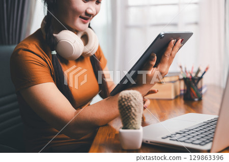 Homeschool Asian girl student learning virtual internet online class from school teacher by remote meeting. Female teaching math by headphone. education concept. student with computer study at school Homeschool Asian girl student learning virtual internet online class from school teacher by remote meeting. Female teaching math by headphone. education concept. student with computer study at school 129863396