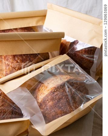 Sourdough Bread Loaf in Transparent Plastic Bag on White Background  129863869