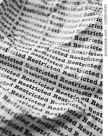 Words Restricted Seamless print on crumpled paper for business background. Words Restricted Seamless print on crumpled paper for business background. 129863889