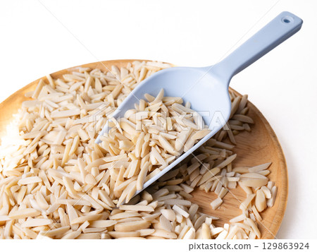 White Almond Stick set on wooden board with versatile scoop and white background. 129863924