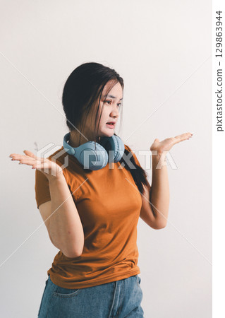 Asian girl expresses dislike, person express negative feeling, concept business complaint from customer ensuring employee satisfaction negative feedback to prevent mental strain customer dislike Asian girl expresses dislike, person express negative feeling, concept business complaint from customer ensuring employee satisfaction negative feedback to prevent mental strain customer dislike 129863944