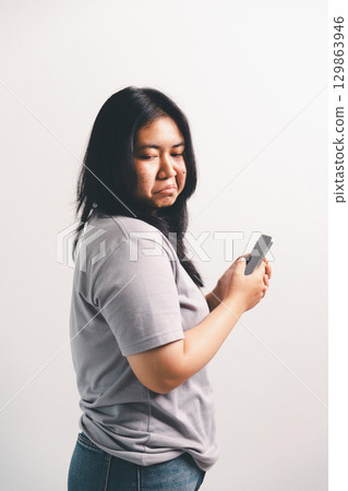 Asian girl expresses dislike, person express negative feeling, concept business complaint from customer ensuring employee satisfaction negative feedback to prevent mental strain customer dislike Asian girl expresses dislike, person express negative feeling, concept business complaint from customer ensuring employee satisfaction negative feedback to prevent mental strain customer dislike 129863946