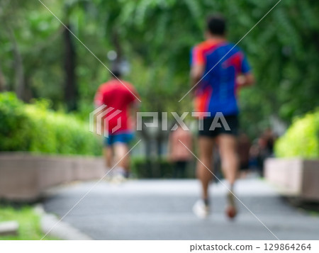 Blurred Runner, Jogger in Public Park, Active Lifestyle Background Blurred Runner, Jogger in Public Park, Active Lifestyle Background 129864264