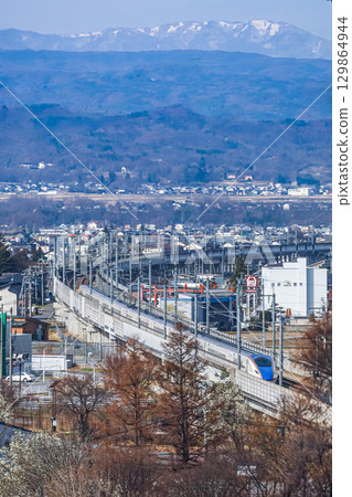 The Hokuriku Shinkansen departing from Sakudaira Station 129864944