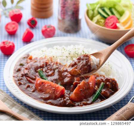 A fragrant tomato curry and rice served with salad - a home-cooked meal A fragrant tomato curry and rice served with salad - a home-cooked meal 129865497