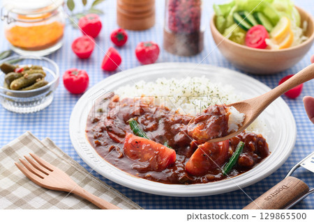 A fragrant tomato curry and rice served with salad - a home-cooked meal A fragrant tomato curry and rice served with salad - a home-cooked meal 129865500