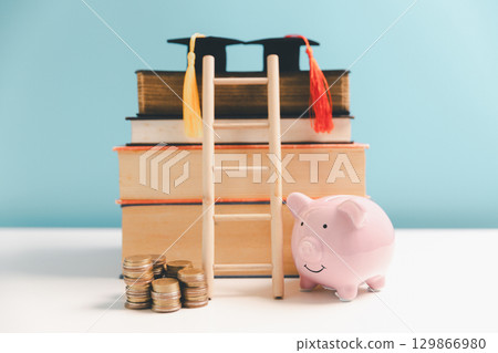 Concept of saving money for education, student loan, scholarship in future. Piggy bank with graduation hat, stack of coins. Earth globe with graduation hat, dollar banknotes on table. Tuition fees Concept of saving money for education, student loan, scholarship in future. Piggy bank with graduation hat, stack of coins. Earth globe with graduation hat, dollar banknotes on table. Tuition fees 129866980
