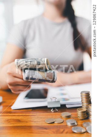 Business, finance and employment, entrepreneur and money concept. Successful young asian office manager, businesswoman showing earned cash, satisfied holding dollars, money dollar bills 129867422