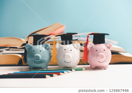 Concept of saving money for education, student loan, scholarship in future. Piggy bank with graduation hat, stack of coins. Earth globe with graduation hat, dollar banknotes on table. Tuition fees Concept of saving money for education, student loan, scholarship in future. Piggy bank with graduation hat, stack of coins. Earth globe with graduation hat, dollar banknotes on table. Tuition fees 129867496