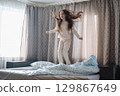A girl with long hair enjoys a peaceful awakening early in the morning. 129867649