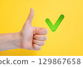 Finger raised up with green check mark, symbolizing approval, agreement, or correct answer 129867658