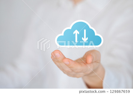 Hand holding digital cloud icon with upload and download arrows, symbolizing data transfer and cloud storage 129867659
