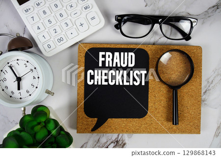Fraud Checklist text with Calculator, alarm clock and magnifying glass on marble background 129868143