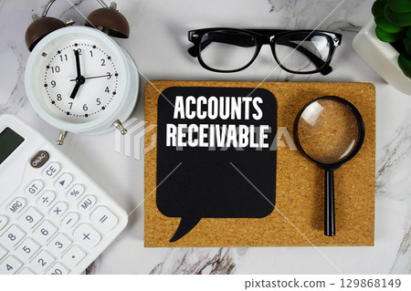 Accounts Receivable text with Calculator, alarm clock and magnifying glass on marble background 129868149