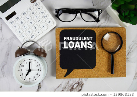Fraudulent Loans text with Calculator, alarm clock and magnifying glass on marble background Fraudulent Loans text with Calculator, alarm clock and magnifying glass on marble background 129868158