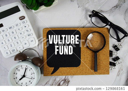 Vulture Fund text with Calculator, alarm clock and magnifying glass on marble background 129868161