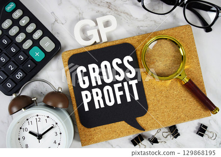 GP Gross Profit text with Calculator, alarm clock and magnifying glass on marble background 129868195