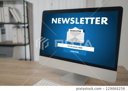 Newsletter subscription concept with modern computer on office desk, showing email signup form on screen for marketing, business communication, and audience engagement in digital workspace. 129868256