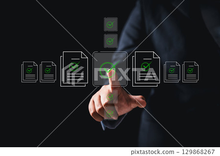 Businesswoman approving digital documents online checklist interface, embracing concept of paperless office task management, business processes, approvals are streamlined through an automated system 129868267