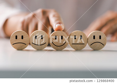 Customer showing rating with happy icon, Customer satisfaction survey concept, Positive feedback from happy client satisfaction with quality of service, marketing surveys, ratings, review, copy space 129868400